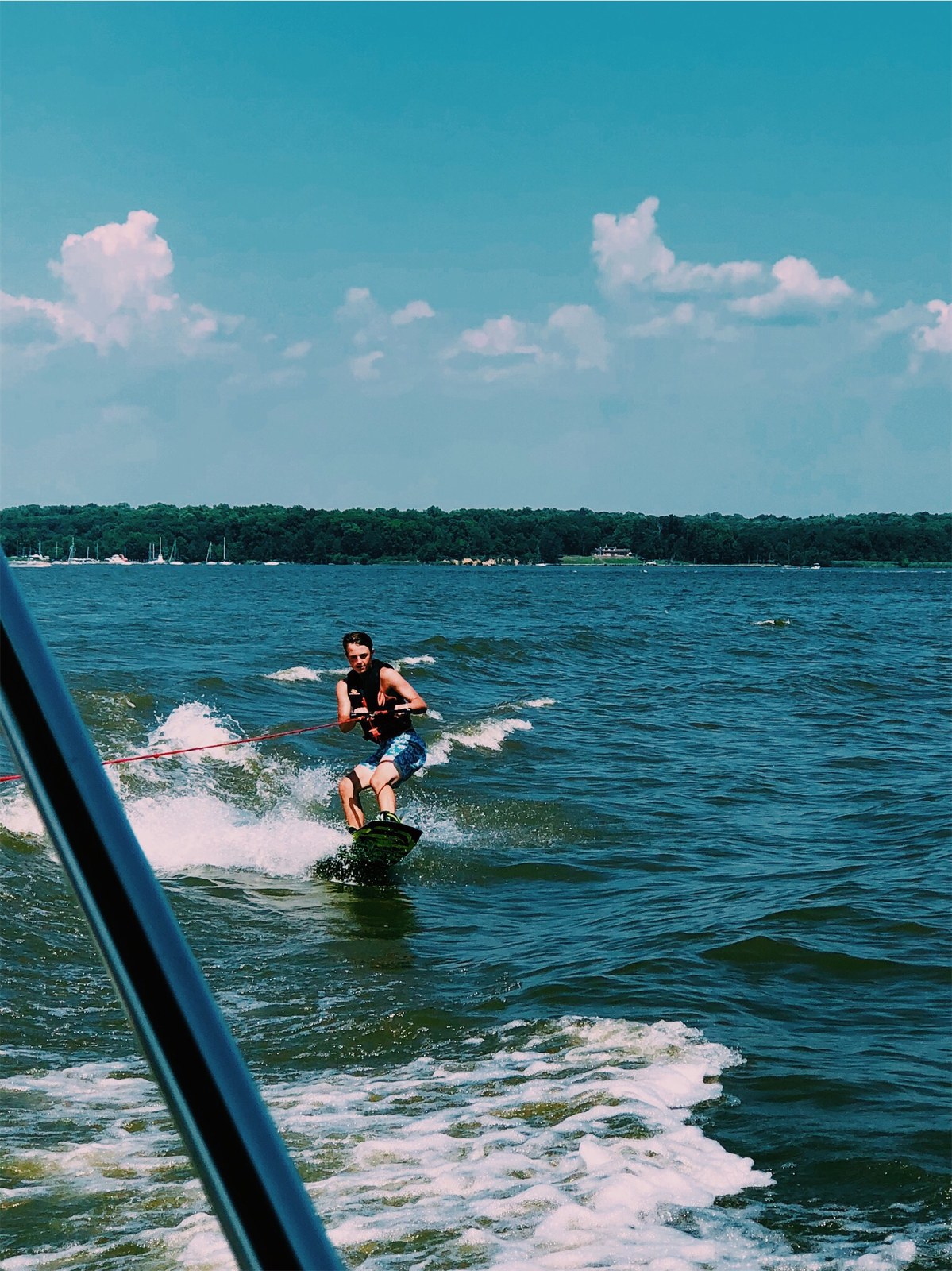 Cole wakeboarding behind the boat
