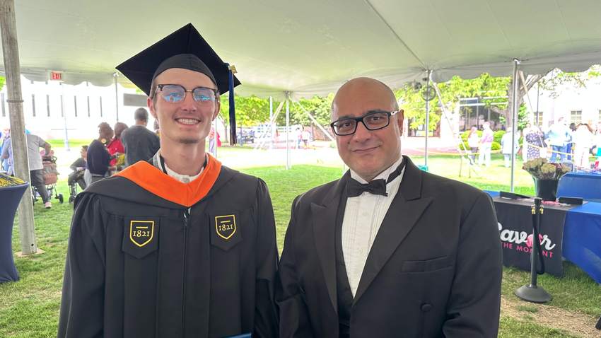 Cole in black robes at his master's graduation